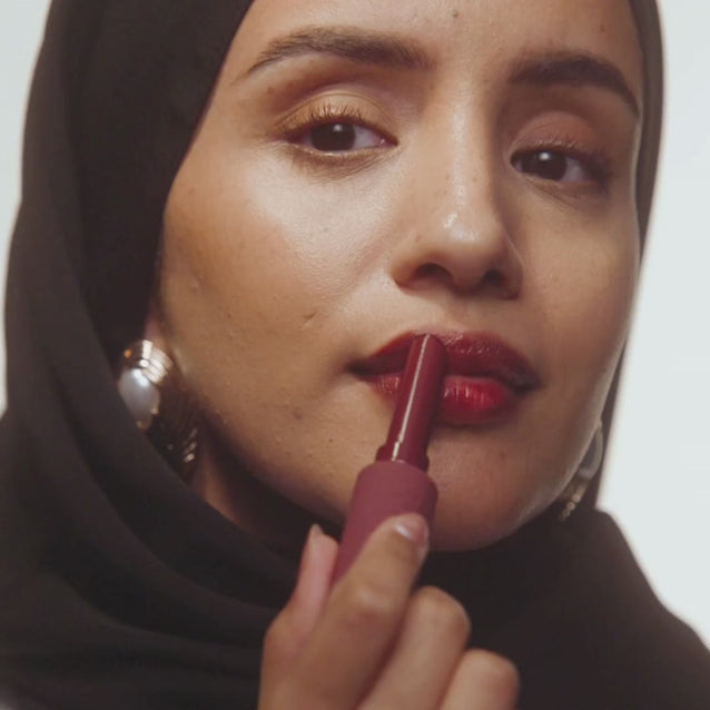 Models on different skin tones applying Voice Note Tinted Lip Treatment Balm in Fang for a glossy cherry lip
