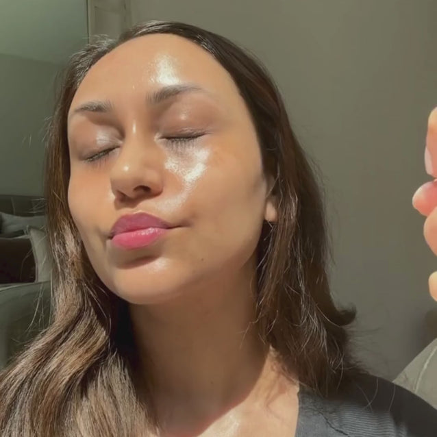 Woman misting Face Fog for an instant dewy, glass-skin glow